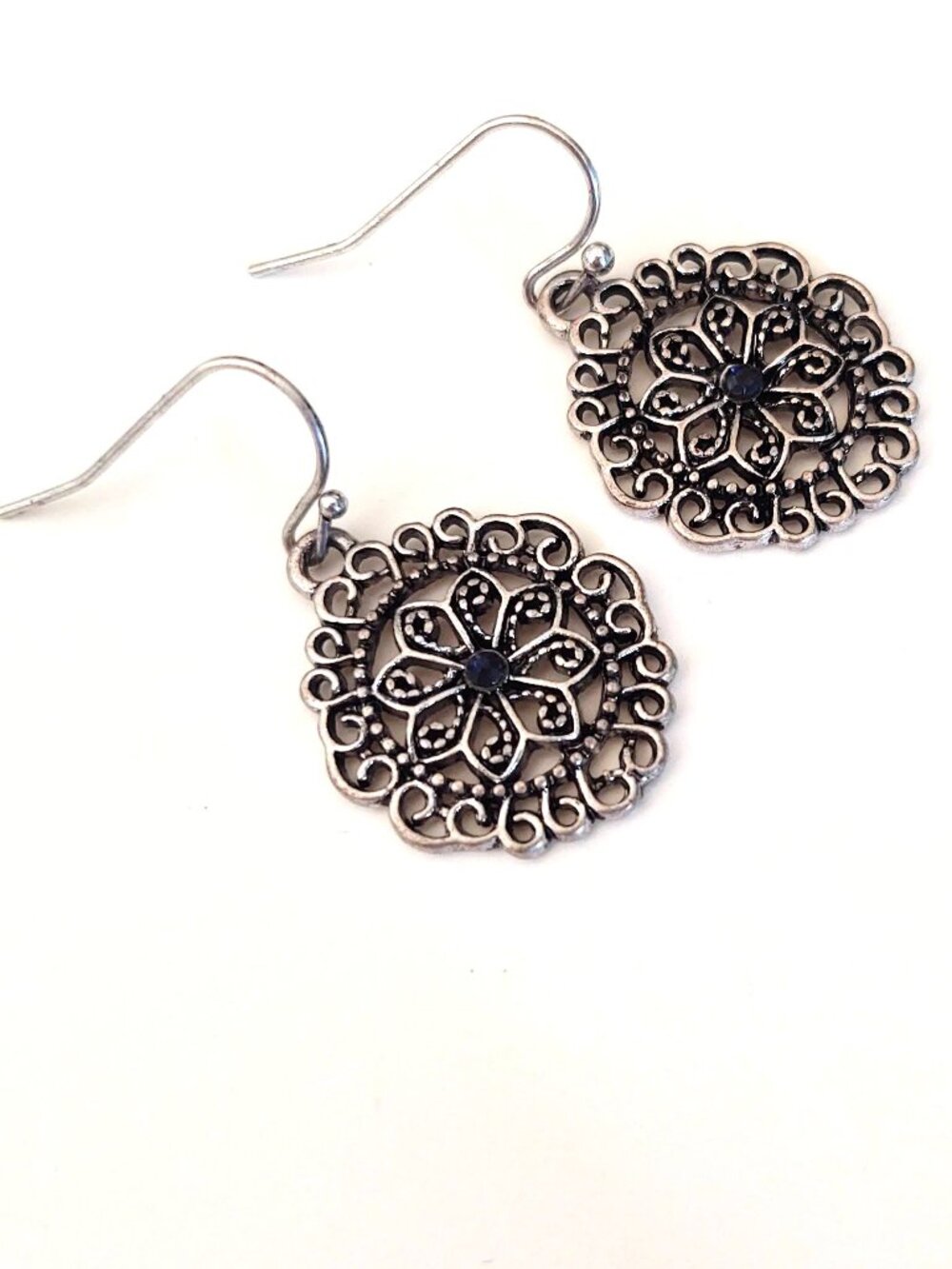 Silver scroll design earrings with blue bead centers